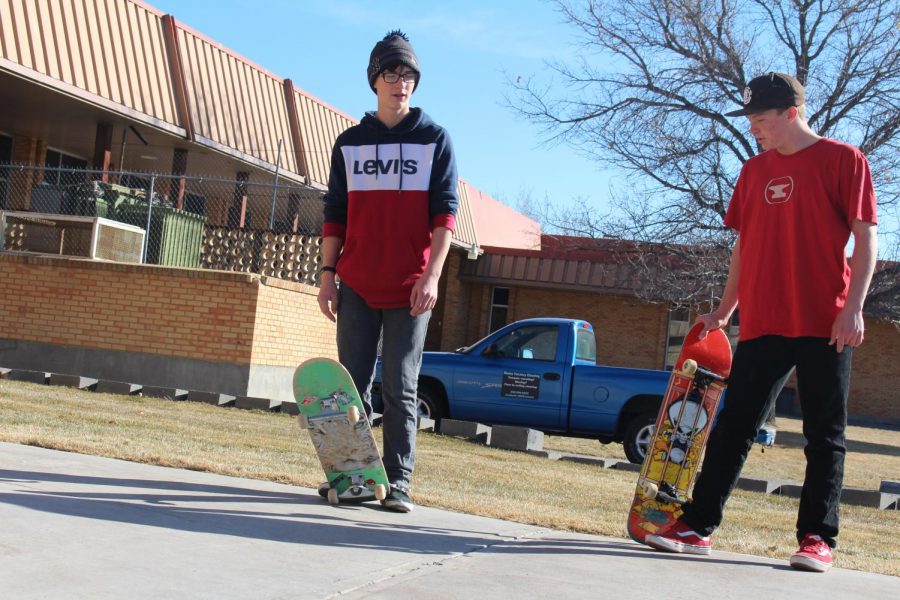 Tristen and Meason posing with skateboards 
