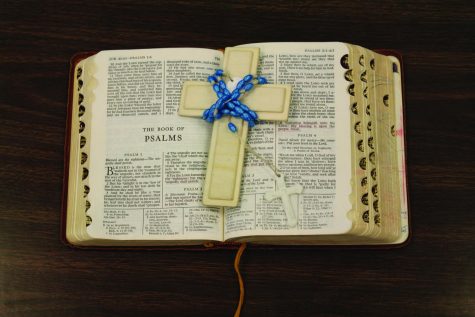 The Bible with a Wooden Cross on top.