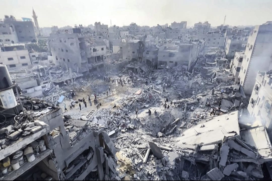 This image grab taken from AFPTV video footage shows Palestinians checking the destruction in the aftermath of an Israeli strike on the Jabalia refugee camp in the Gaza Strip, on November 1, 2023, amid ongoing battles between Israel and the Palestinian Hamas movement. Thousands of civilians, both Palestinians and Israelis, have died since October 7, 2023, after Palestinian Hamas militants based in the Gaza Strip entered southern Israel in an unprecedented attack triggering a war declared by Israel on Hamas with retaliatory bombings on Gaza. (Photo by AFP)